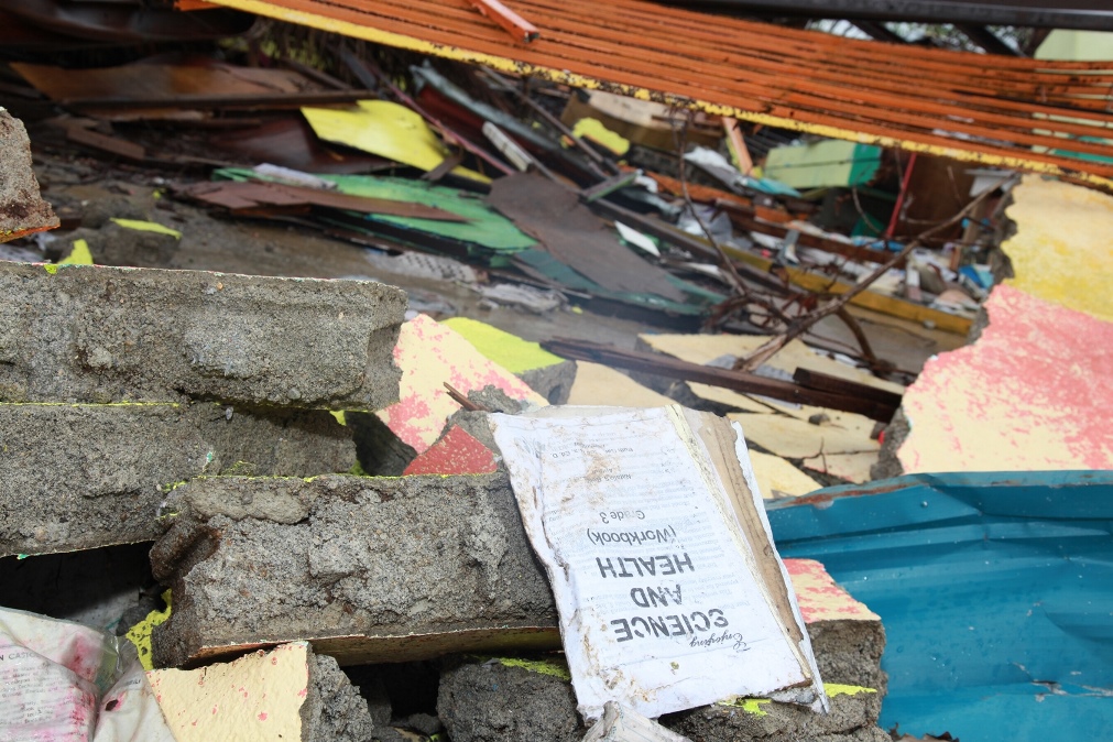 A school workbook amidst the ruins.